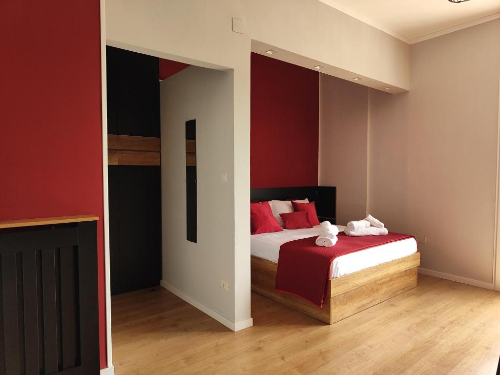 a bedroom with a bed with red walls at B&B LIBRA rooms & suite in Salerno