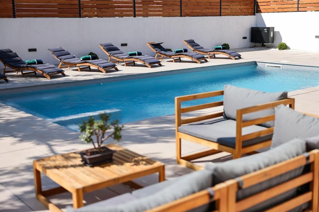 a group of chairs sitting next to a swimming pool at Villa Elaia in Sukošan
