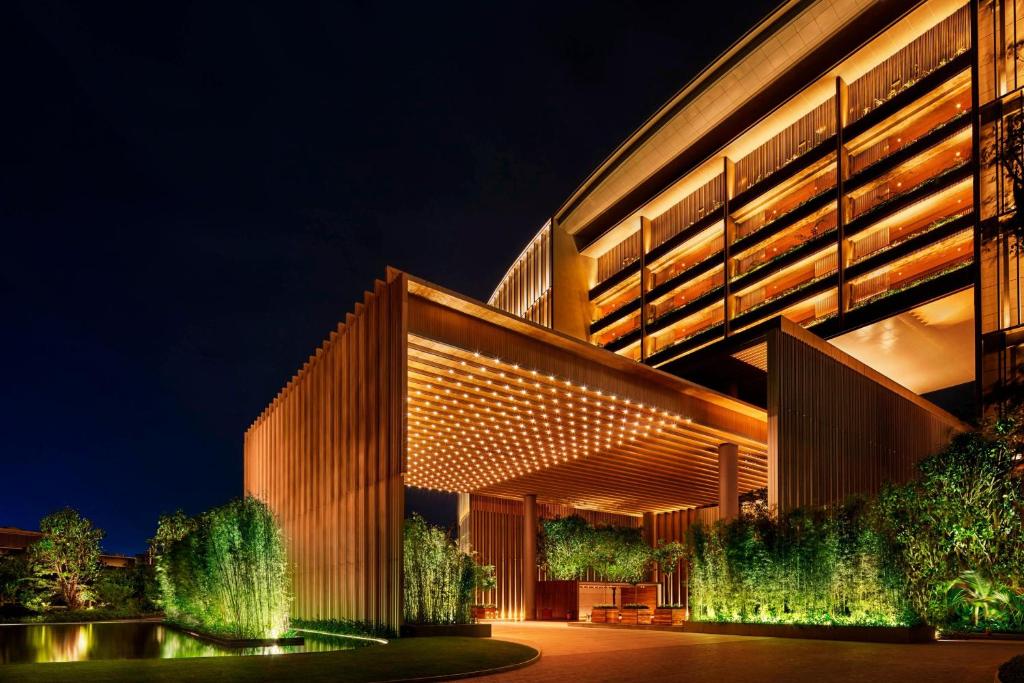 a building with lights on it at night at The Sanya EDITION in Sanya