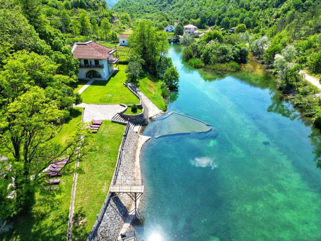 an aerial view of a river with a house at Jazina Hotel in Trebinje