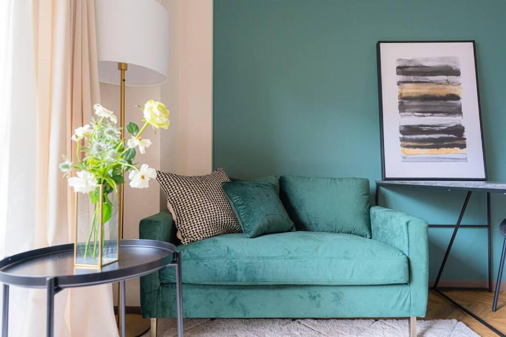 a living room with a green couch and a table at Well-rent 名古屋丸の内 in Nagoya