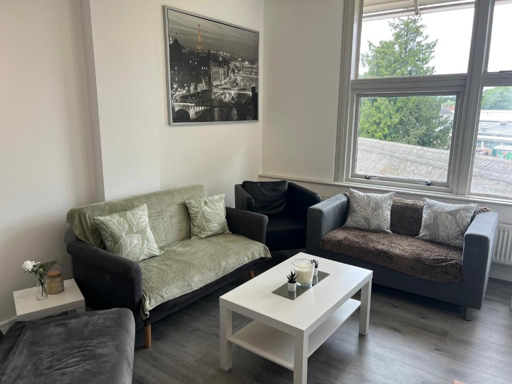 a living room with two couches and a coffee table at 3 Bedroom Flat in Town Centre in Wellingborough