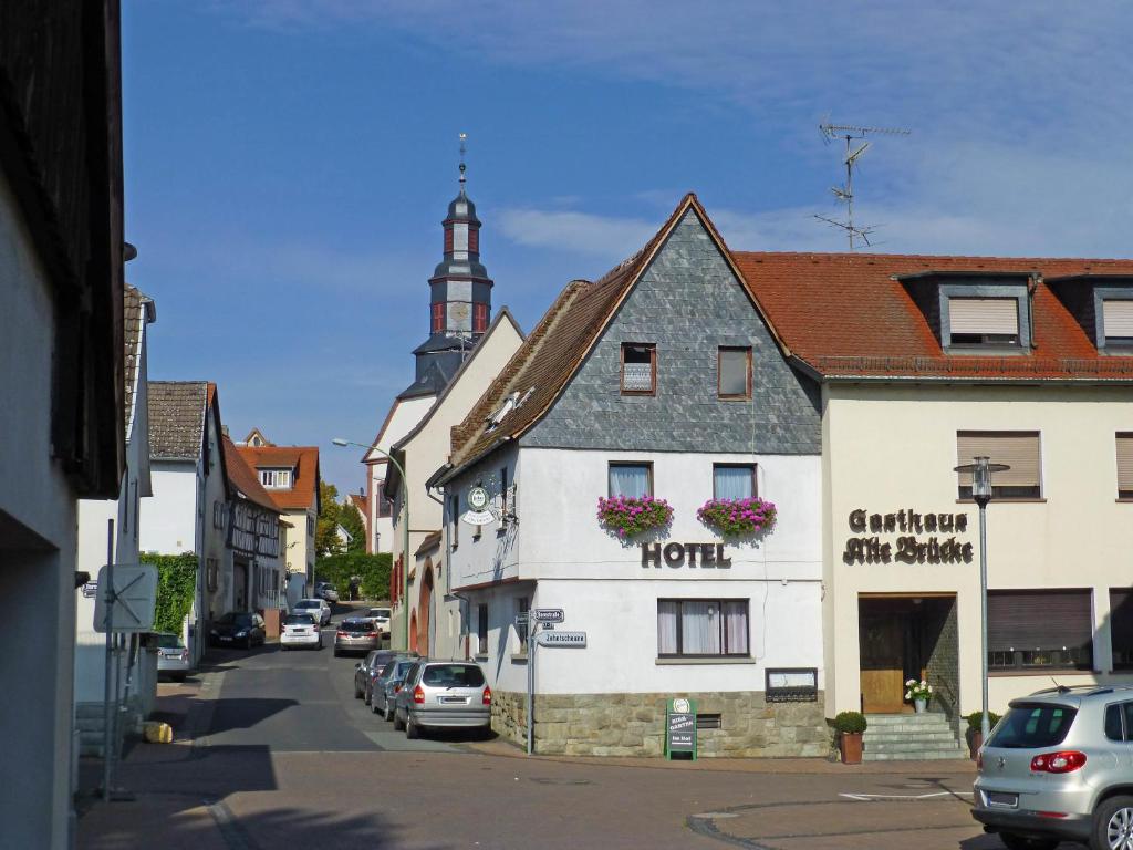 a street in a small town with a hotel at Hotel Alte Brücke in Bad Homburg vor der Höhe