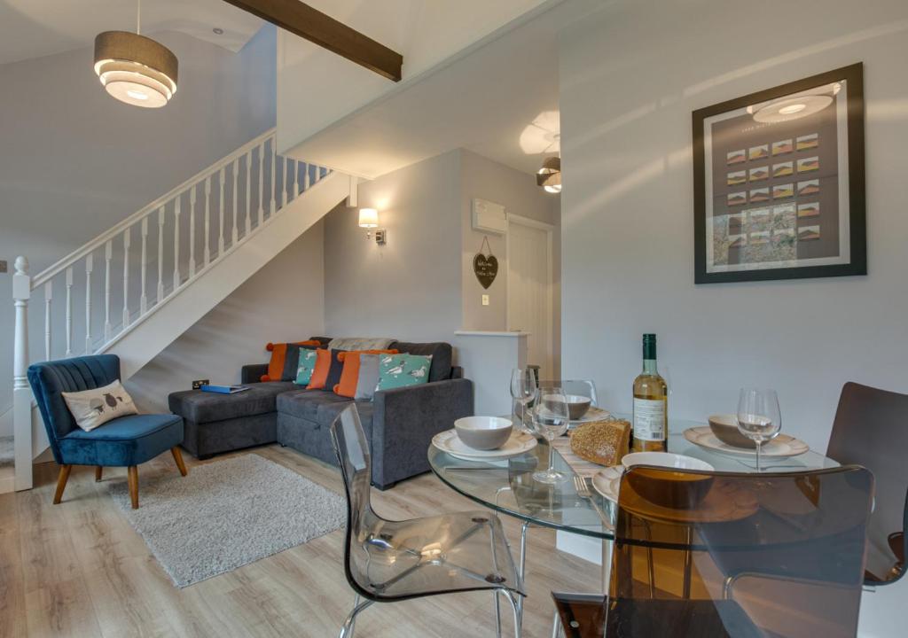 a living room with a table and a couch at Toffee Cottage in Chapel Stile