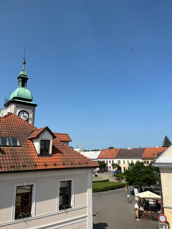 a building with a clock tower on top of it at Penzion U Radnice in Doksy