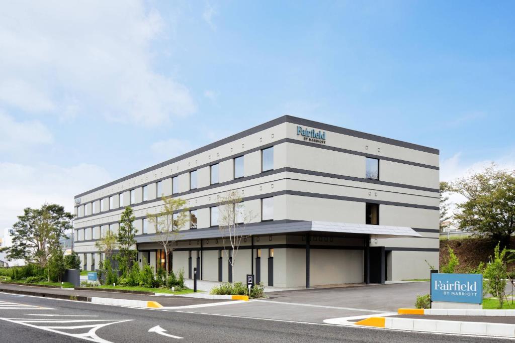 a large white building with a road in front of it at Fairfield by Marriott Mie Kumano Kodo Mihama in Mihama