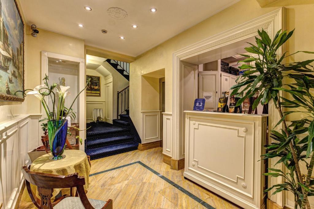 a hallway of a home with a staircase and a table at Palazzo La Scala in Venice