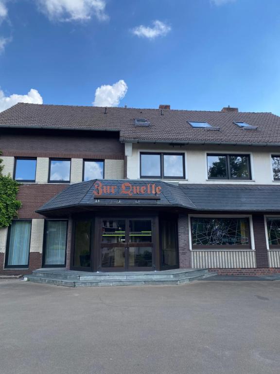 a brick building with a first divide sign on it at Bistro-zur-Quelle in Minden