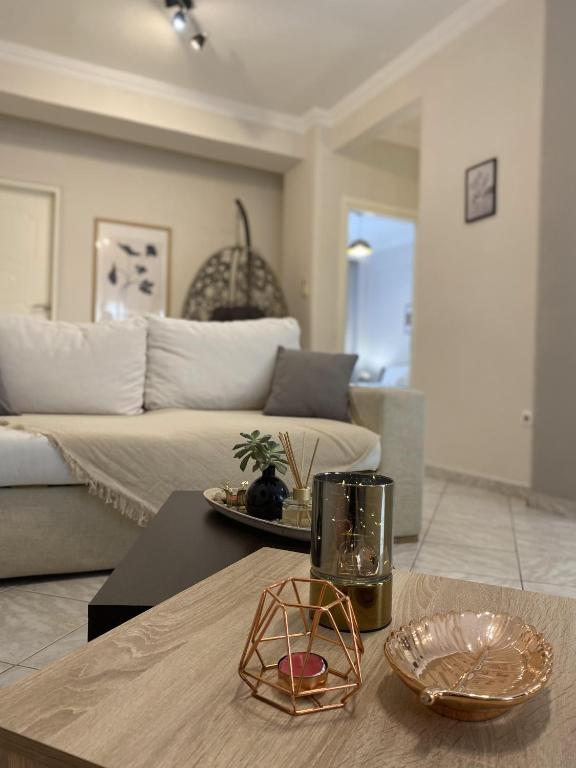 a living room with a couch and a table at Sweet Home Ano Poli in Thessaloniki