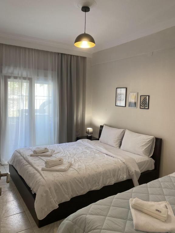1 dormitorio con 2 camas y ventana en Sweet Home Ano Poli en Tesalónica