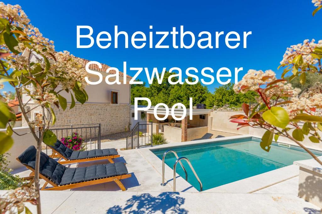 a villa with a swimming pool in a garden at Villa Oasa in Malinska