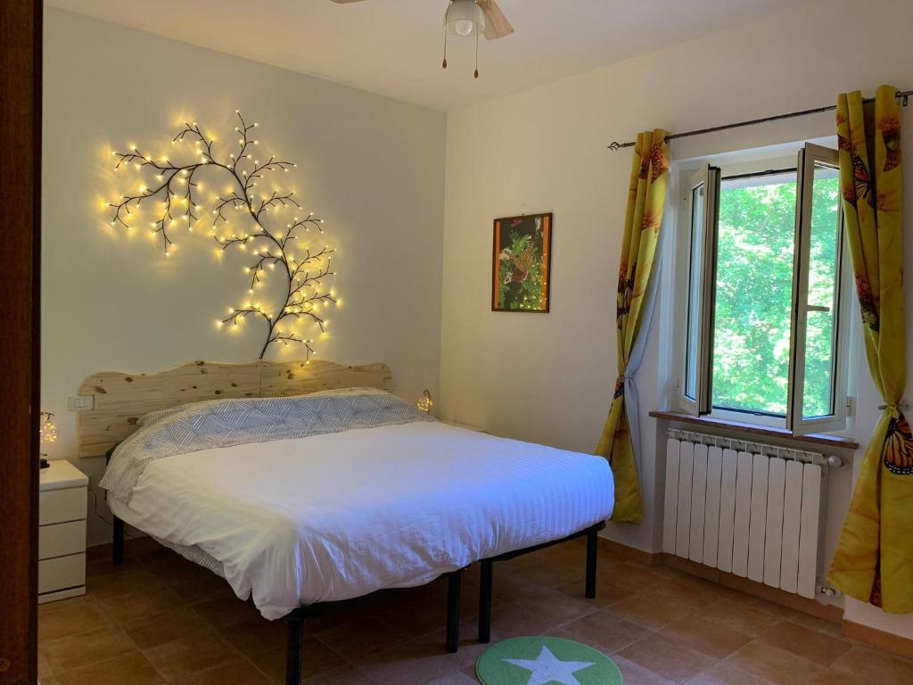 a bedroom with a bed with lights on the wall at Butterflies Rest in Gubbio