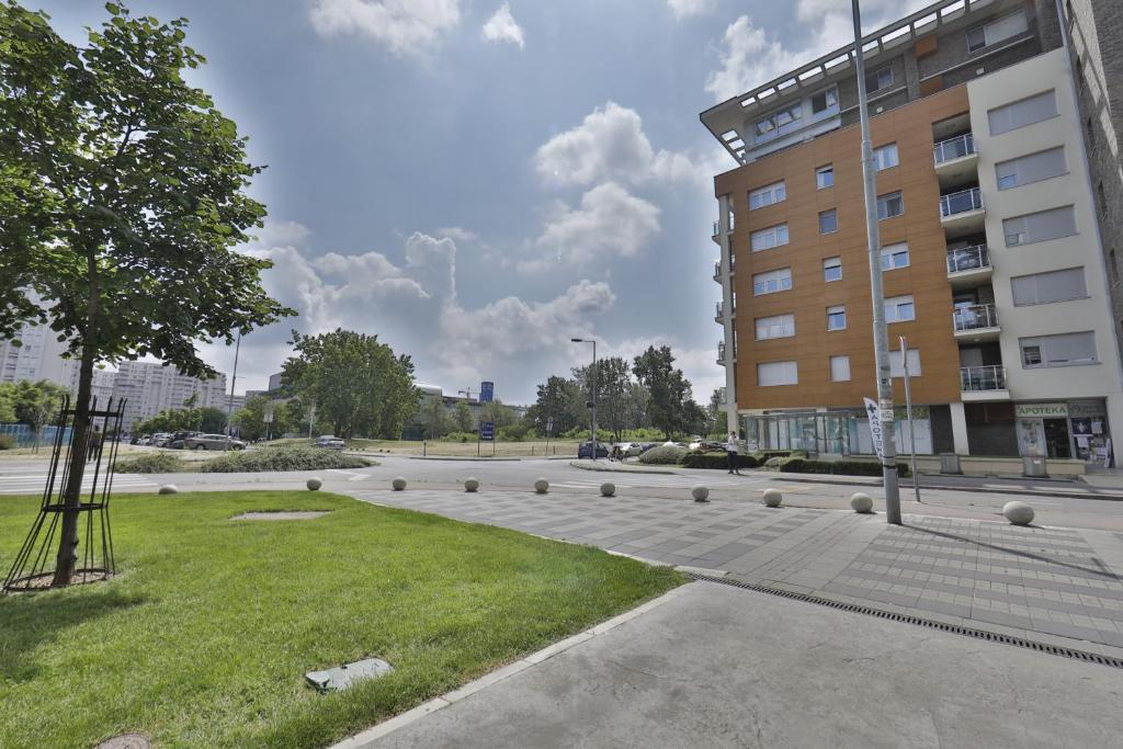 a parking lot in front of a building at A blok - One bedroom apartment in Belgrade