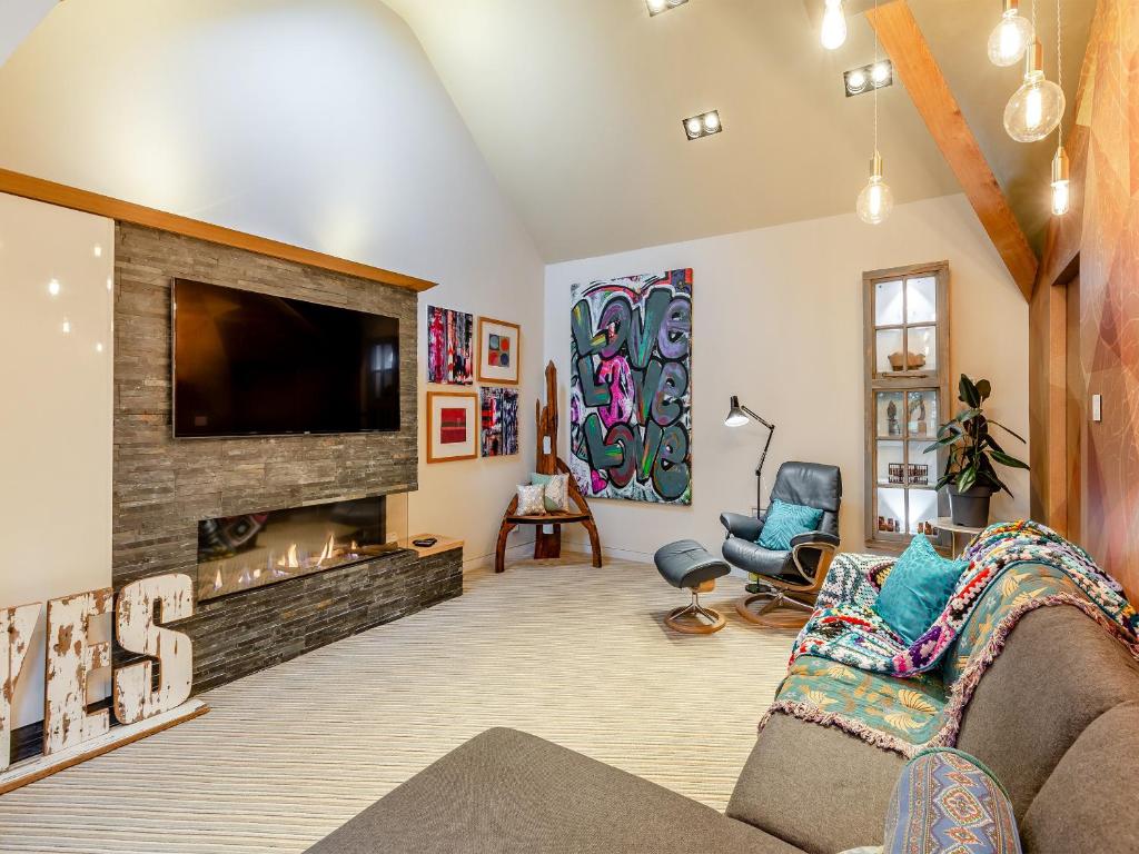 a living room with a fireplace and a tv at The Stables in Longridge