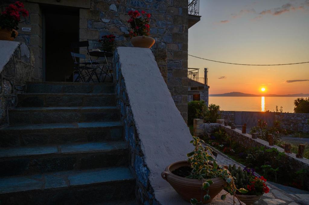 a set of stairs with a sunset in the background at Μαϊστράλι in Kotrónion