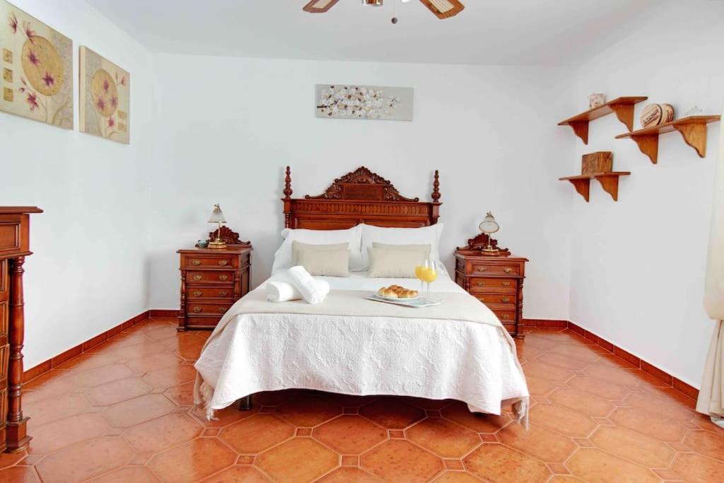 a bedroom with a bed with a plate of food on it at Duplex temático Andaluz con agradable terraza - El Mirador de Benahavis 2 in Benahavís