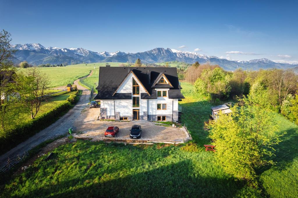 an aerial view of a house in a field at Apartamenty Widok Tatr in Zakopane