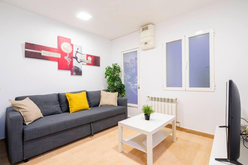 a living room with a couch and a tv at Cosy interior ground floor in Barrio Salamanca-BOC5 in Madrid