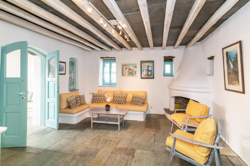 a living room with a couch and a table at Galatea House Katoï with patio in Káto Klísma