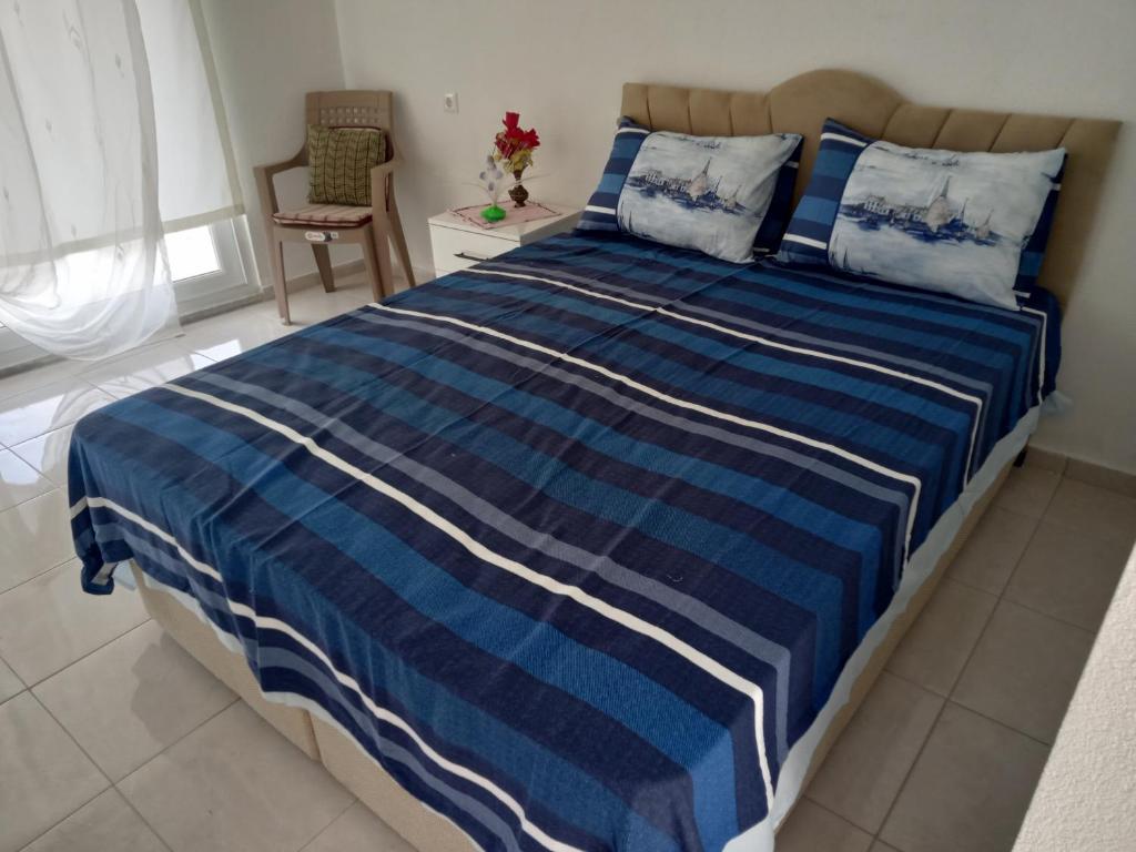 a blue and white bed in a bedroom at Kır evi in Mugla