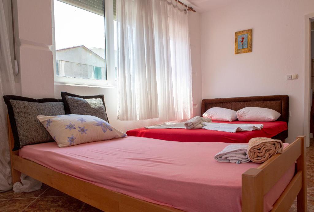 Postel nebo postele na pokoji v ubytování Family Apartments Vukcevic