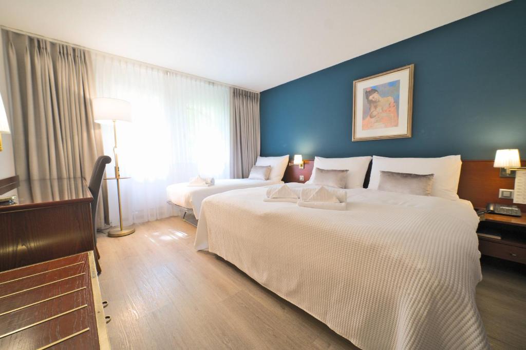 Postel nebo postele na pokoji v ubytování Tulip Inn Beaulieu Lausanne