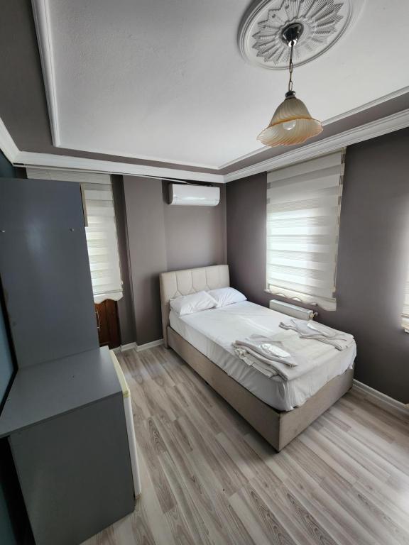 a bedroom with a bed and a ceiling at KALMUK SUIT in Trabzon