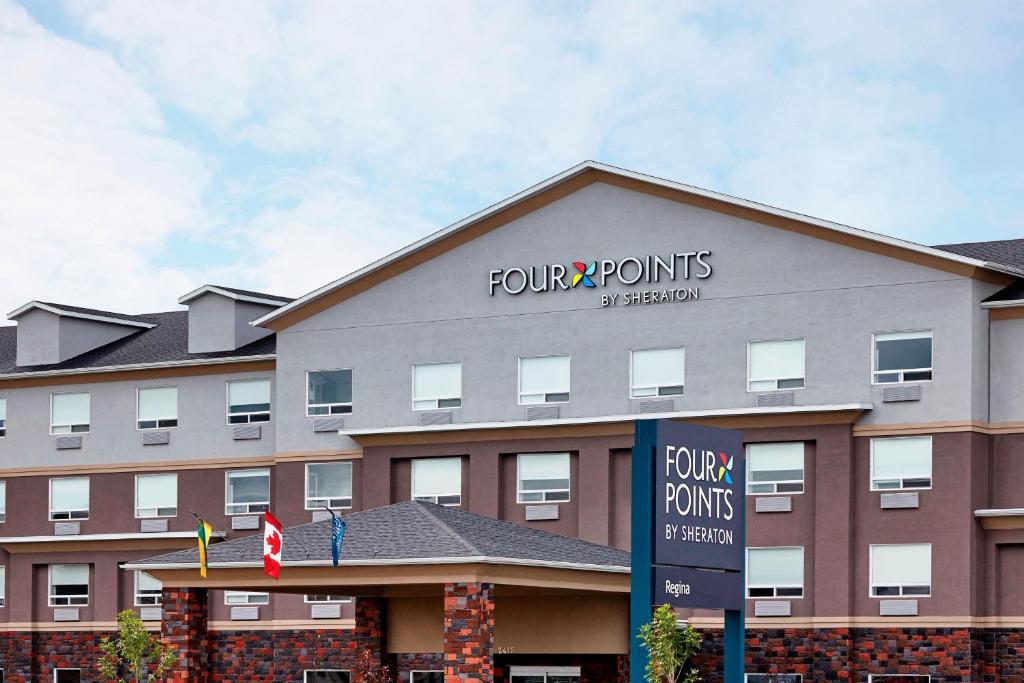 a front view of a hotel with a sign on it at Four Points by Sheraton Regina in Regina