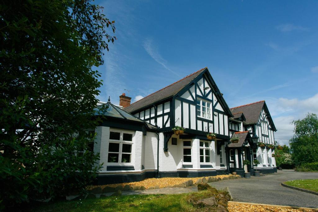 a house with black and white trim on a street at The Egerton Arms in Chester