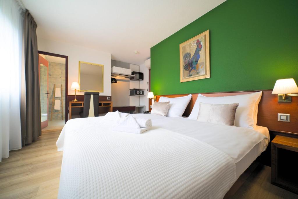 Postel nebo postele na pokoji v ubytování Tulip Inn Beaulieu Lausanne