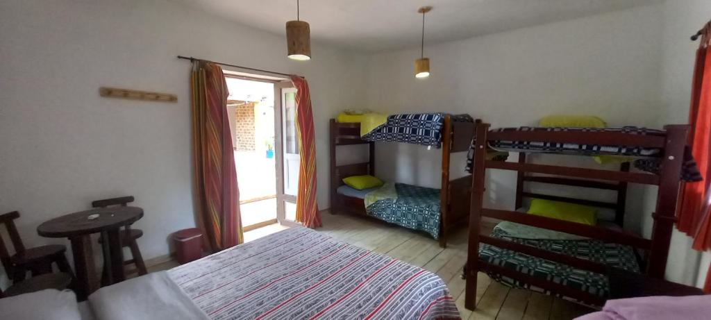 a bedroom with two bunk beds and a window at Venta del Espino in Zipaquirá