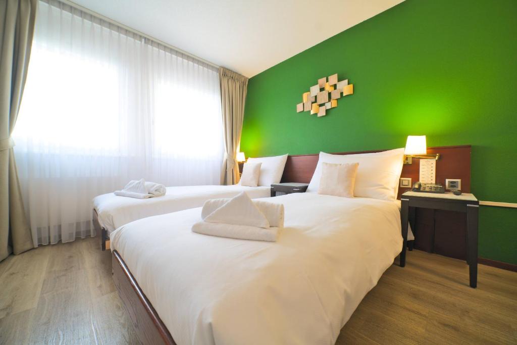 Postel nebo postele na pokoji v ubytování Tulip Inn Beaulieu Lausanne