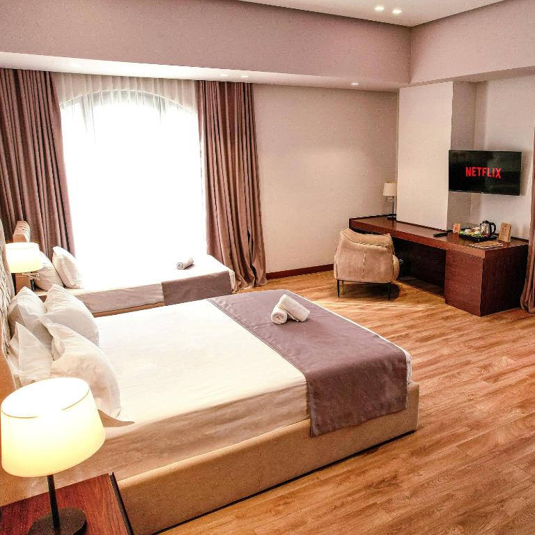 Uma cama ou camas num quarto em Portik Hotel
