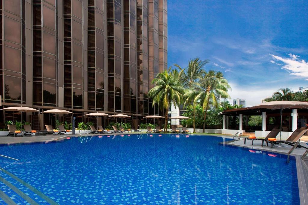 a large swimming pool in front of a building at Sheraton Towers Singapore Hotel in Singapore