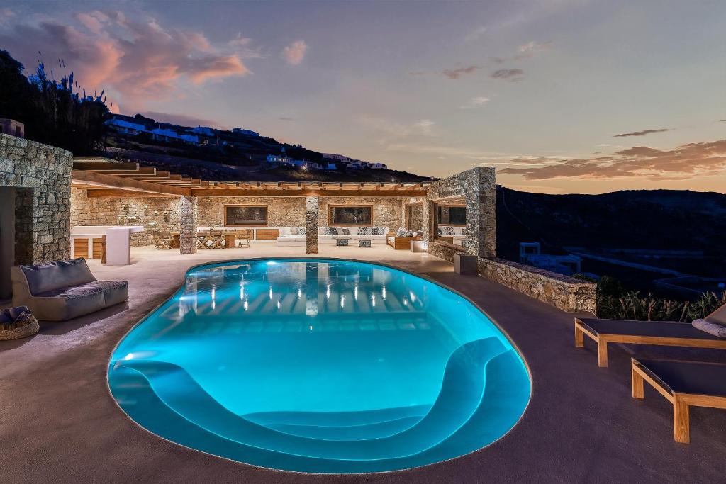 a swimming pool in the middle of a house at Christina's Panormos Villa in Panormos Mykonos