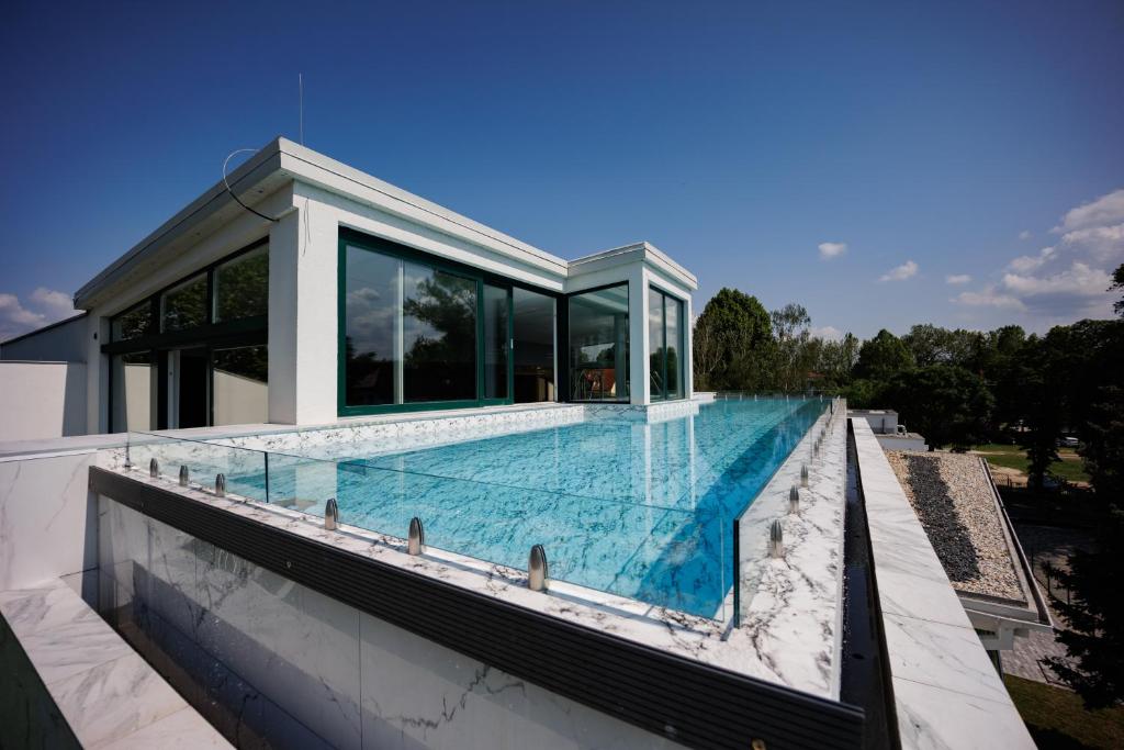 a swimming pool on the roof of a house at Villa Bauhaus Wellness Apartman 102 in Siófok