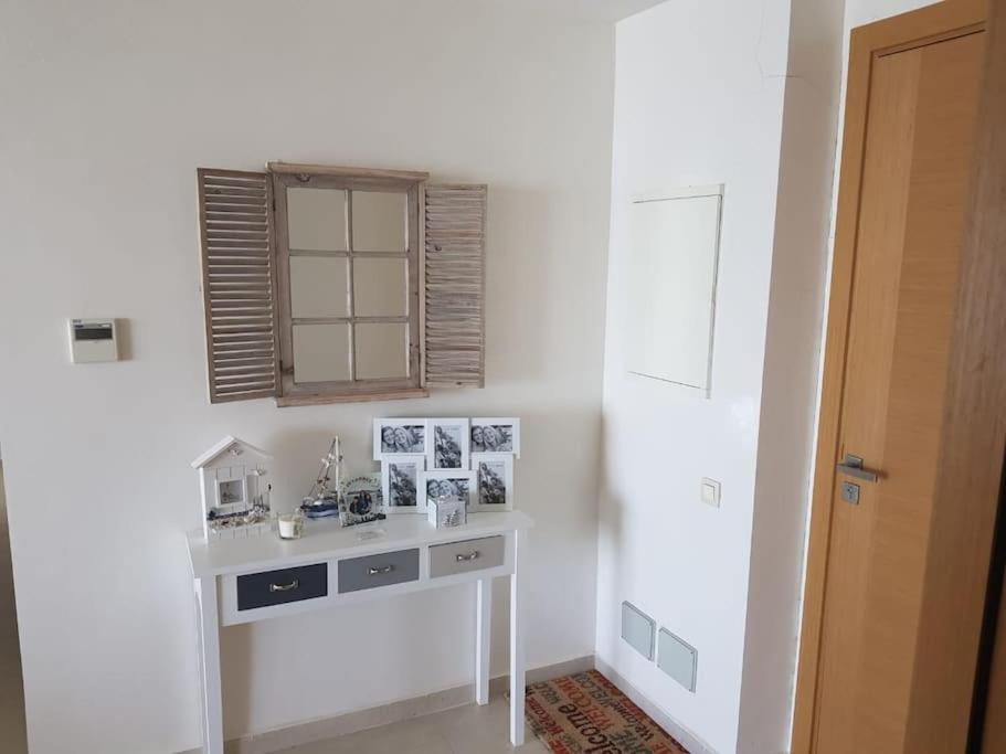 a white desk in a room with a window at Lujoso aprtamento cap tingis playa tanger in Tangier