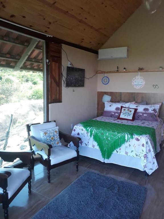 Postel nebo postele na pokoji v ubytování Chalé Mirante da Pedra