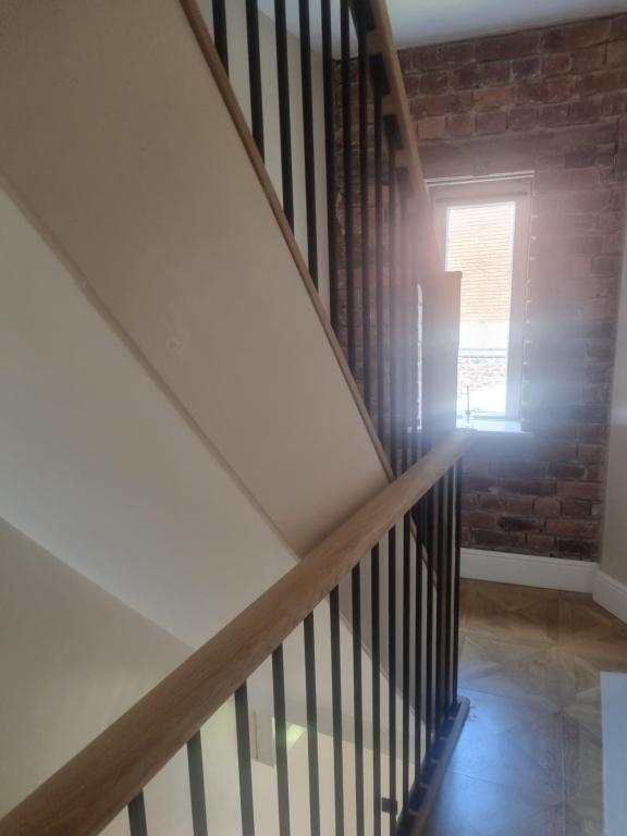 a staircase with a window and a brick wall at Grade ll listed holiday home in Llanidloes