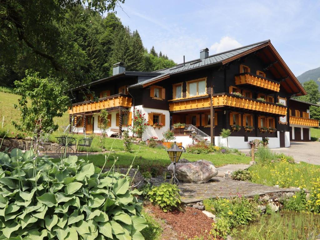 a house with a garden in front of it at Enzianhof in Silbertal