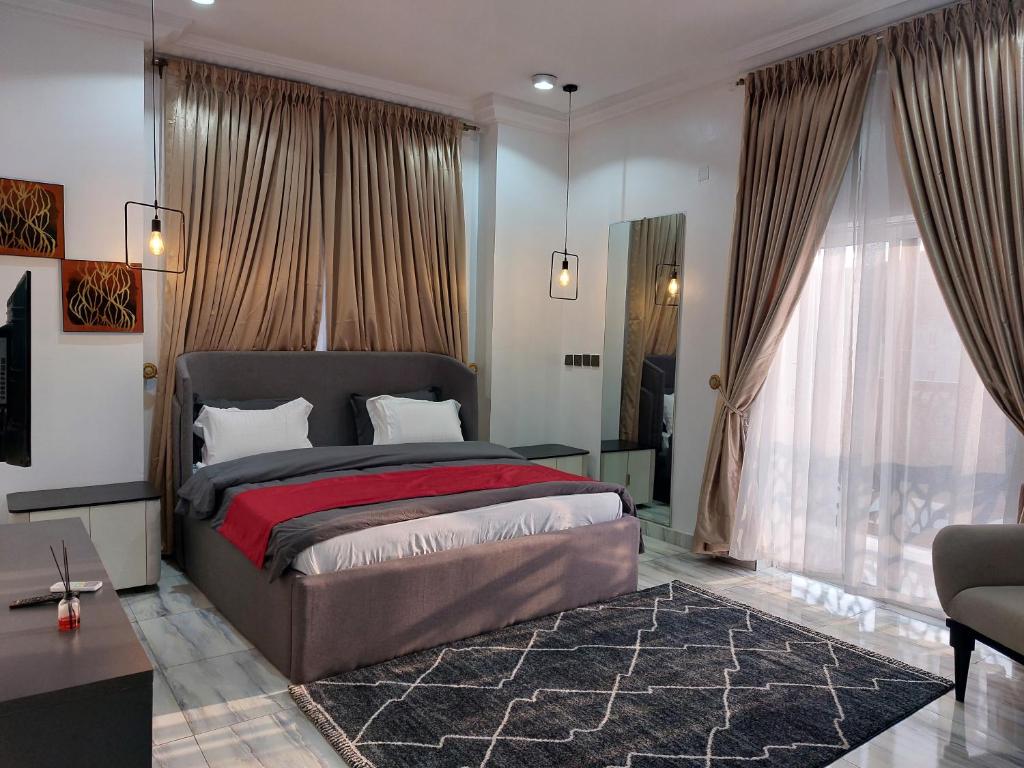 a bedroom with a large bed and a living room at Officer Condo Apartments in Yanyan