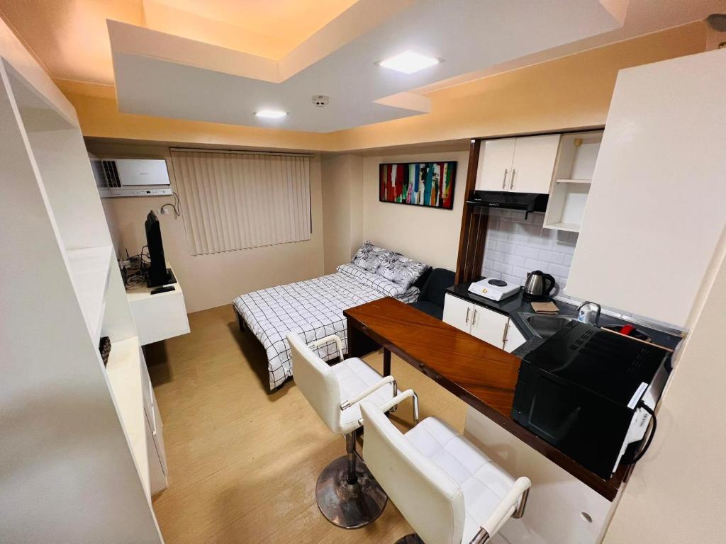 a small room with a bed and a table and chairs at D Peaceful and Comfortable Room in Iloilo City