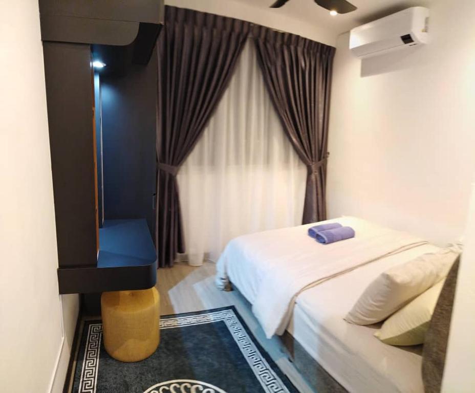 a hotel room with a bed and a window at D&Q METROCITY GUESTHOUSE in Kuching