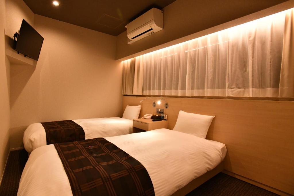 Postel nebo postele na pokoji v ubytování FL Hotel Dotonbori