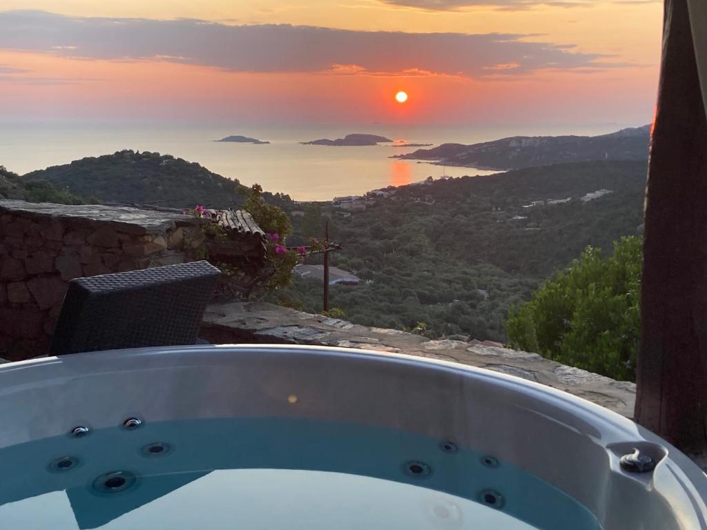 a bath tub with a view of the sunset at SuiteHome PeveroView&SPApool in Porto Cervo