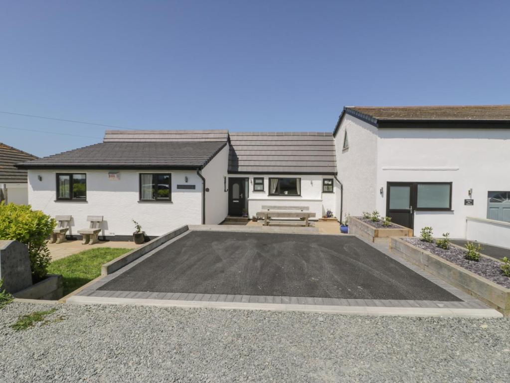 a house with a parking lot in front of it at Minerva in Holyhead