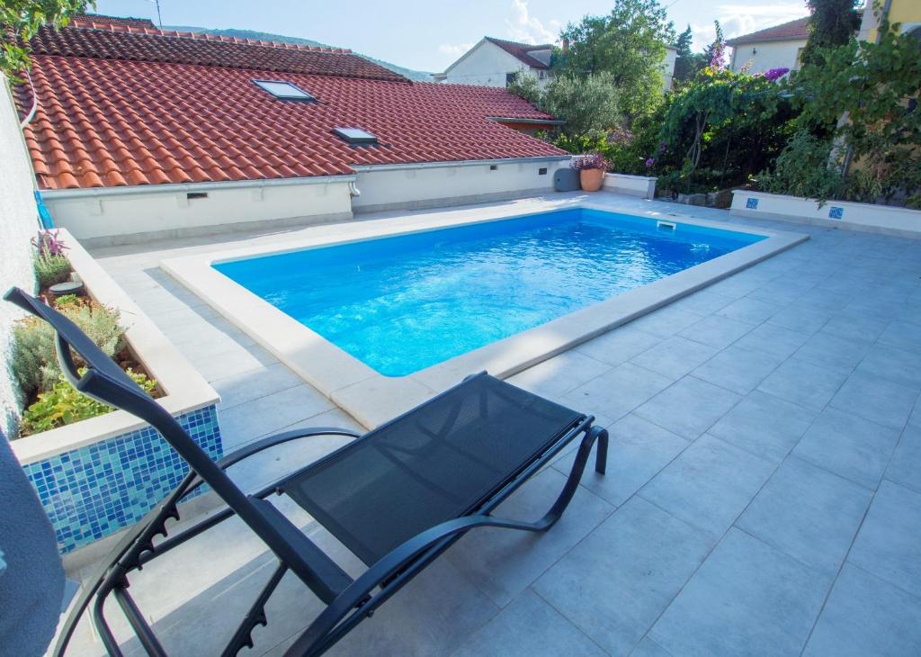 - une piscine avec une chaise sur la terrasse dans l'établissement Apartment Kova - with pool, à Stari Grad
