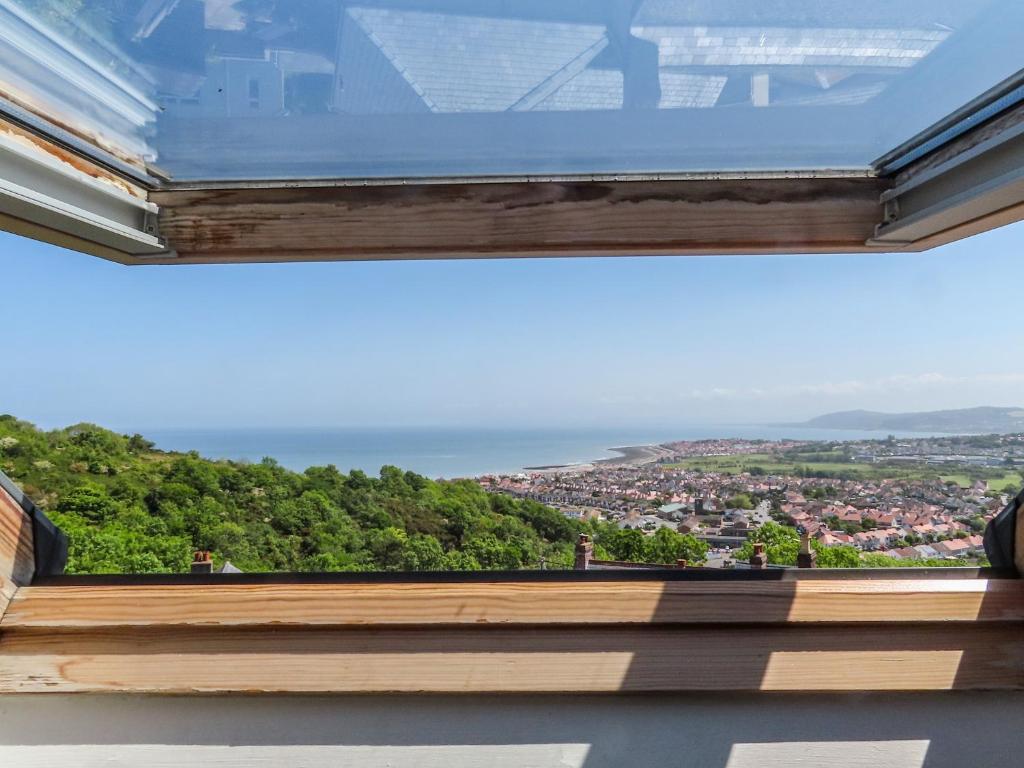 a view of the ocean from a window in a house at Bryn Tirion - Penrhynside in Conwy