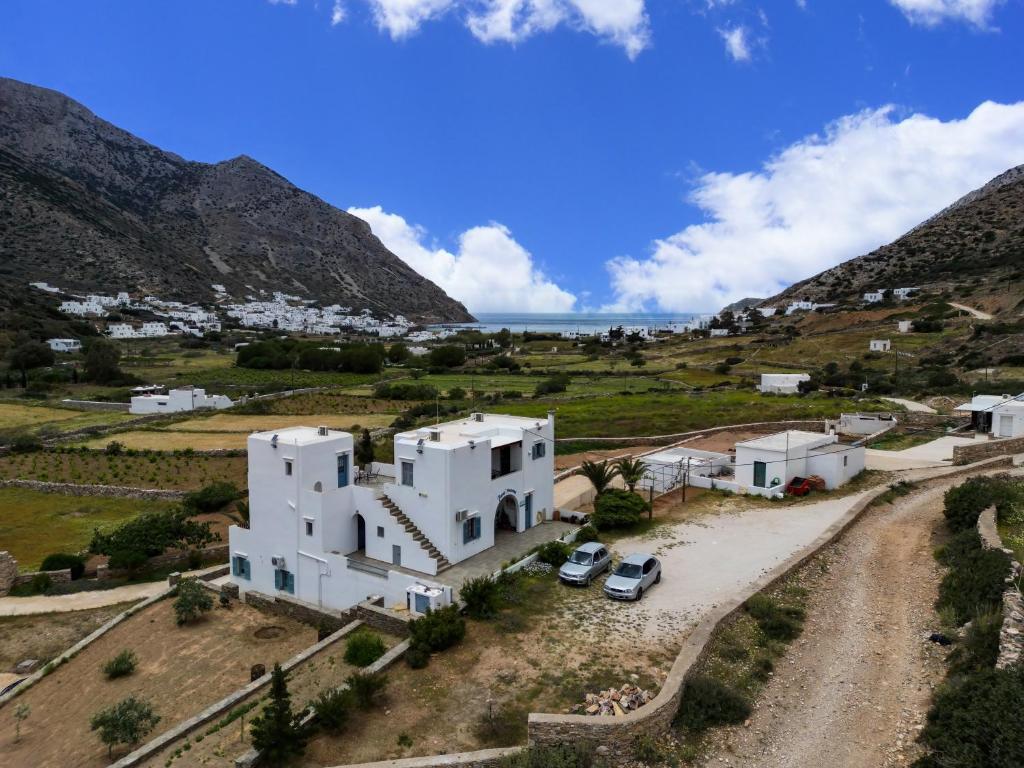 an aerial view of a white house in a mountain at Peris Rooms in Sifnos