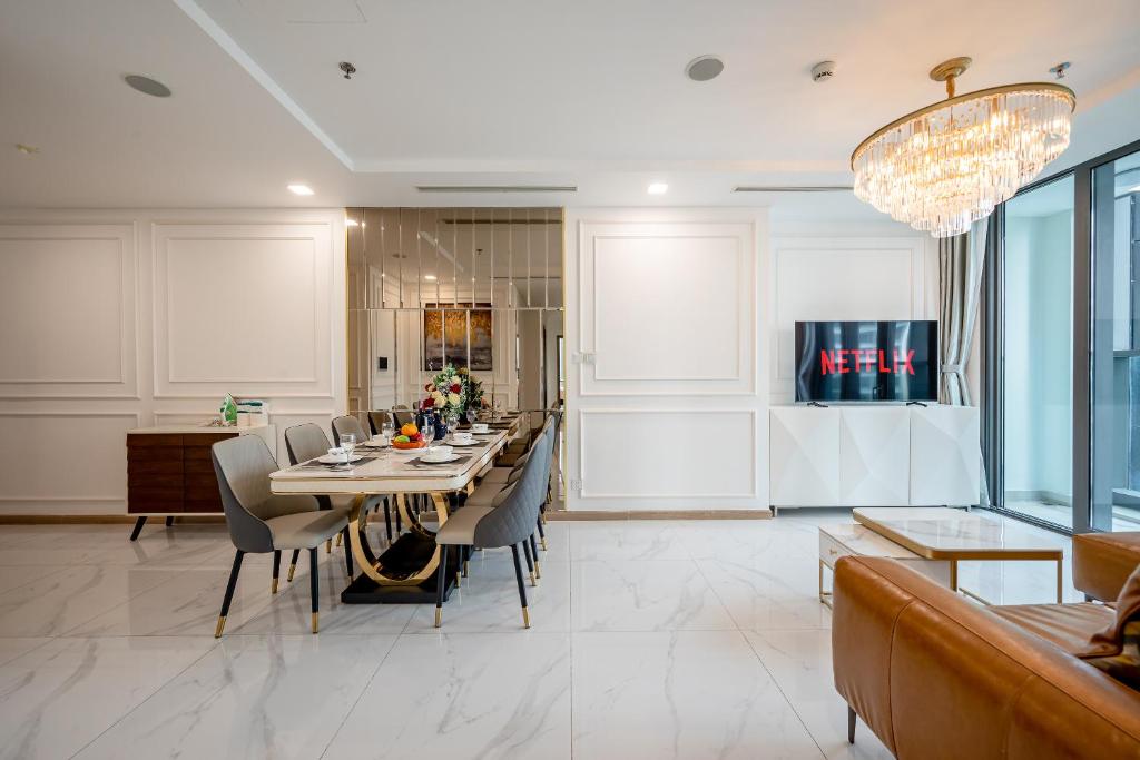 a dining room with a long table and chairs at Landmark 81 Vinhomes Central Park Luxury Apartment in Ho Chi Minh City
